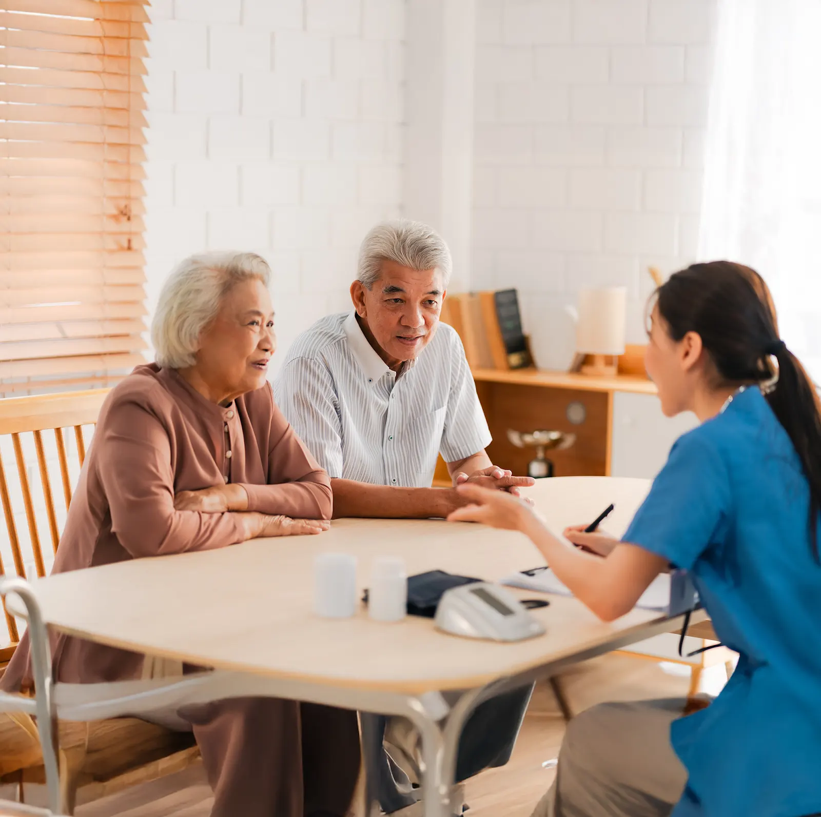 Older couple discussing preventive checkup results with a clinician