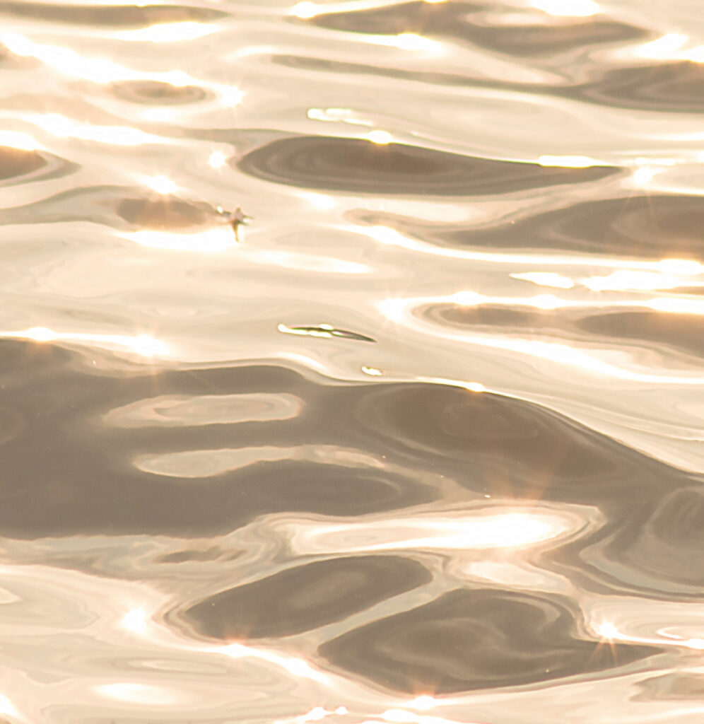 Sunlight rippling across calm water at Bang Saen